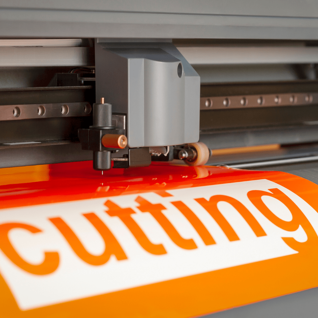 Orange paper coming of cutter with word cutting engraved